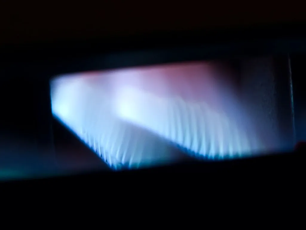 Blue gas burner flames inside a furnace