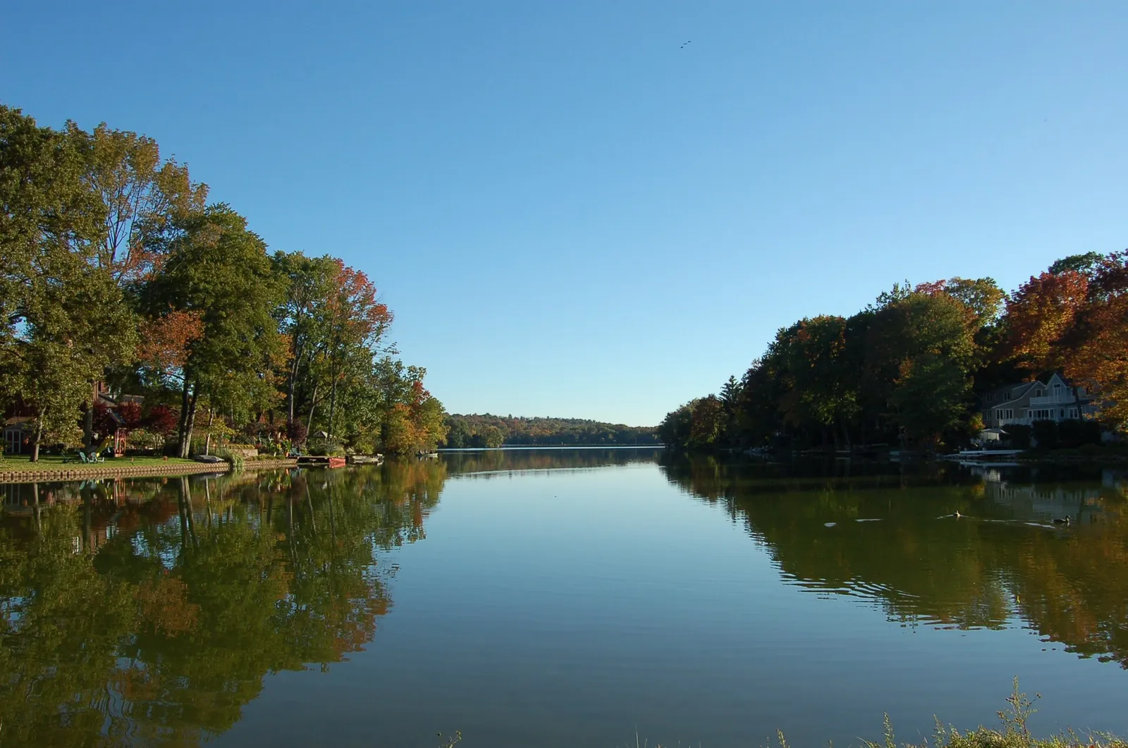 Packanack Lake in Wayne, New Jersey with fall trees along the shore